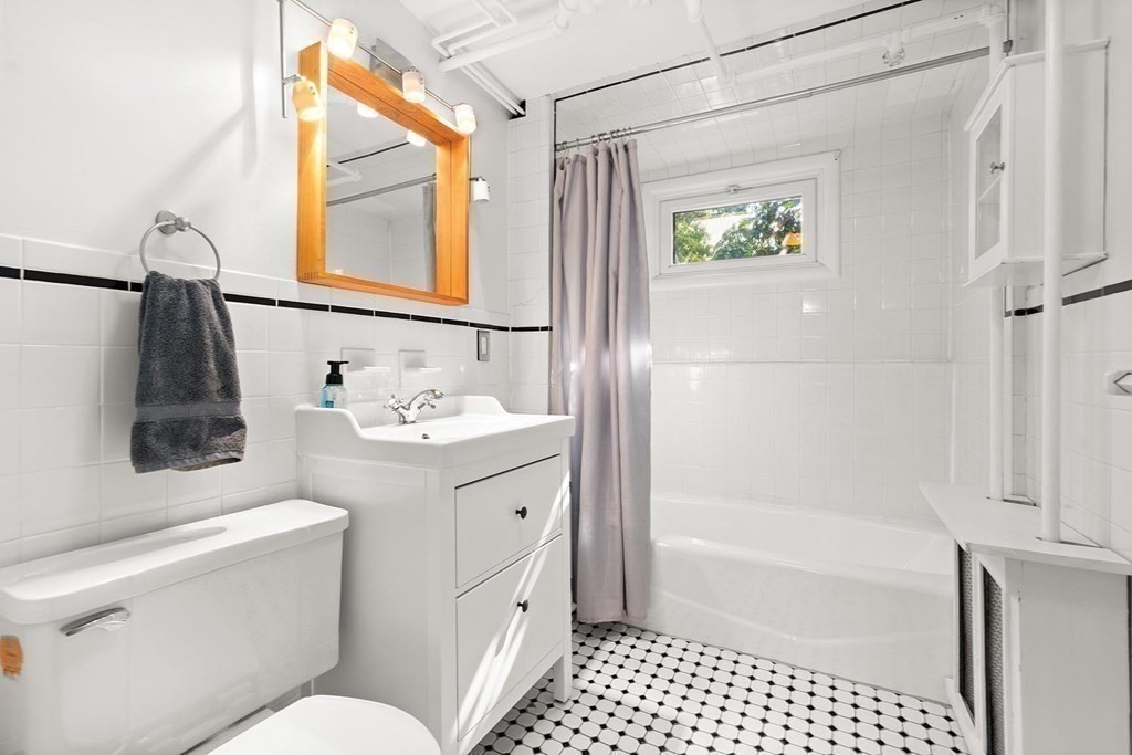 44 Rolling Lane Newton, MA 02467 - Photo 15 of 18 a bathroom with a sink a toilet and a bathtub