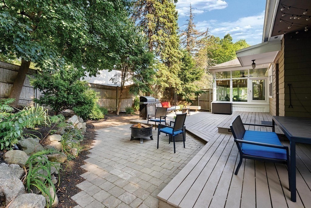 44 Rolling Lane Newton, MA 02467 - Photo 17 of 18 a view of a patio with couches and table and chairs with wooden floor and fence