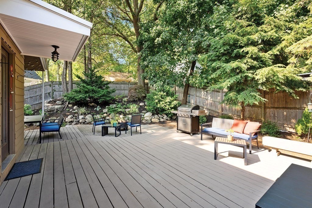44 Rolling Lane Newton, MA 02467 - Photo 18 of 18 a roof deck with table and chairs couches with wooden floor and fence