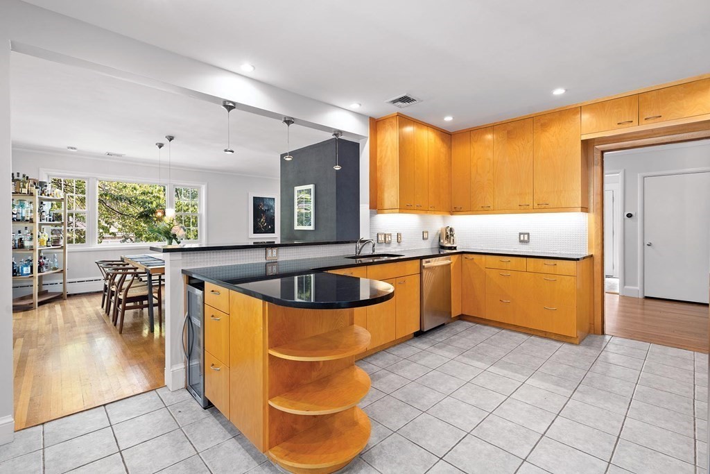 44 Rolling Lane Newton, MA 02467 - Photo 9 of 18 a kitchen with stainless steel appliances a sink a counter top space and a view of kitchen