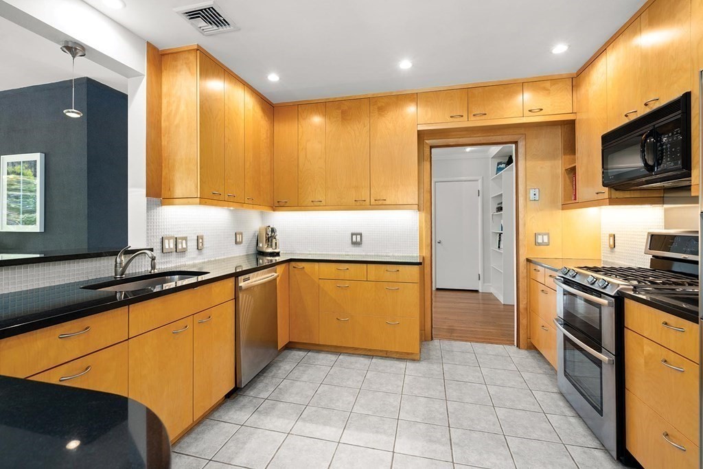 44 Rolling Lane Newton, MA 02467 - Photo 10 of 18 a kitchen with stainless steel appliances granite countertop a sink and cabinets