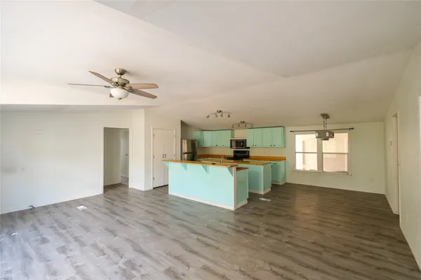 a kitchen with a refrigerator and a sink