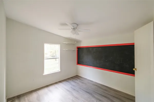 a room with wooden floor and window