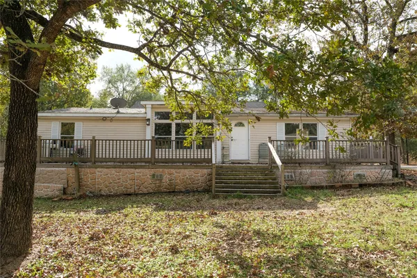 front view of a house with a bench