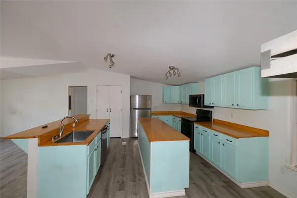 a kitchen that has a sink and a stove