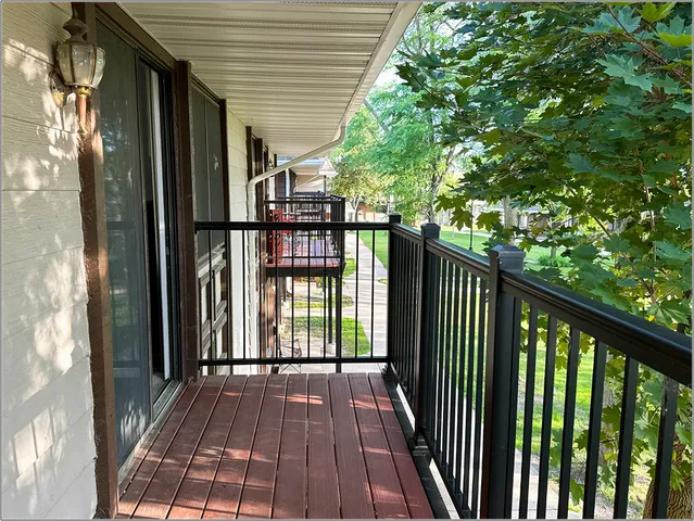 a view of balcony with wooden floor