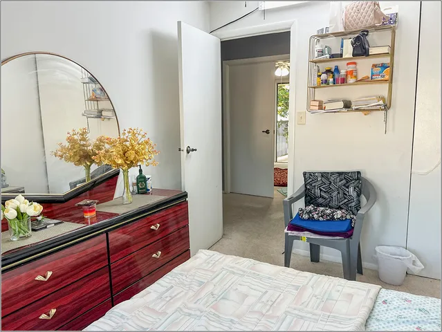 a bedroom with a bed and a dresser in it