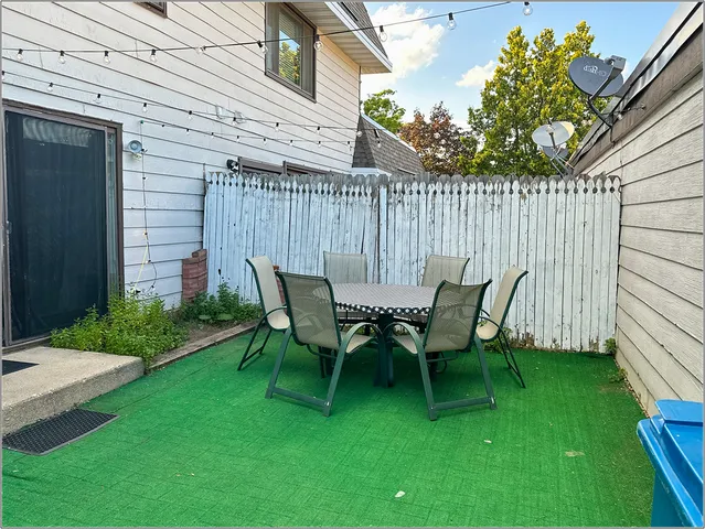 a view of a chairs and table in backyard of the house