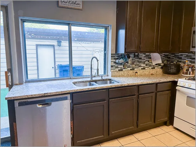 a kitchen with sink cabinets and window