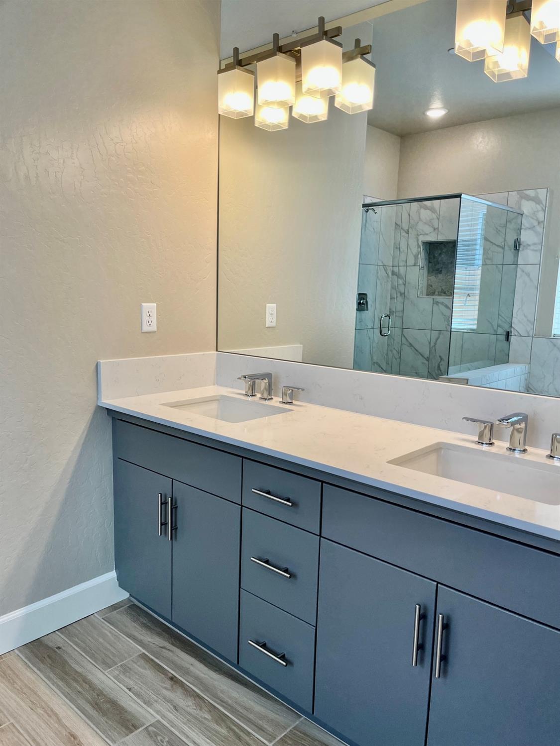 465 Bloom Lane Clovis, CA 93619 - Photo 11 of 16 a bathroom with a sink double vanity and a mirror
