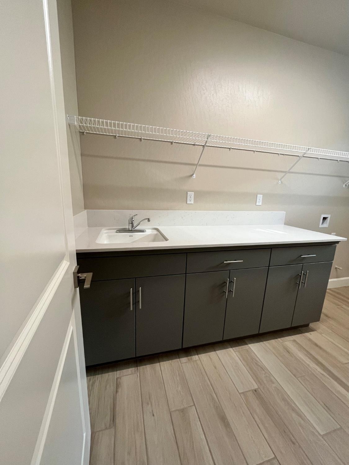 465 Bloom Lane Clovis, CA 93619 - Photo 13 of 16 a kitchen with a sink and cabinets