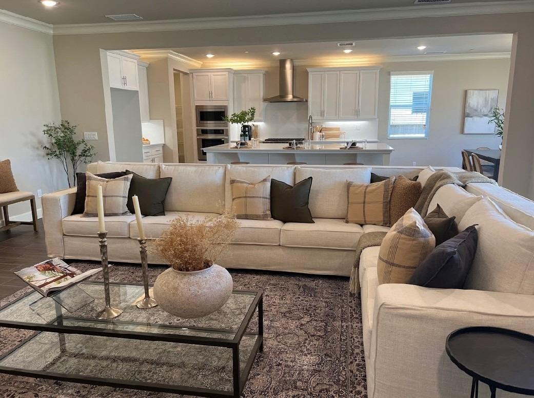 465 Bloom Lane Clovis, CA 93619 - Photo 2 of 16 a living room with furniture and a dining table with kitchen view