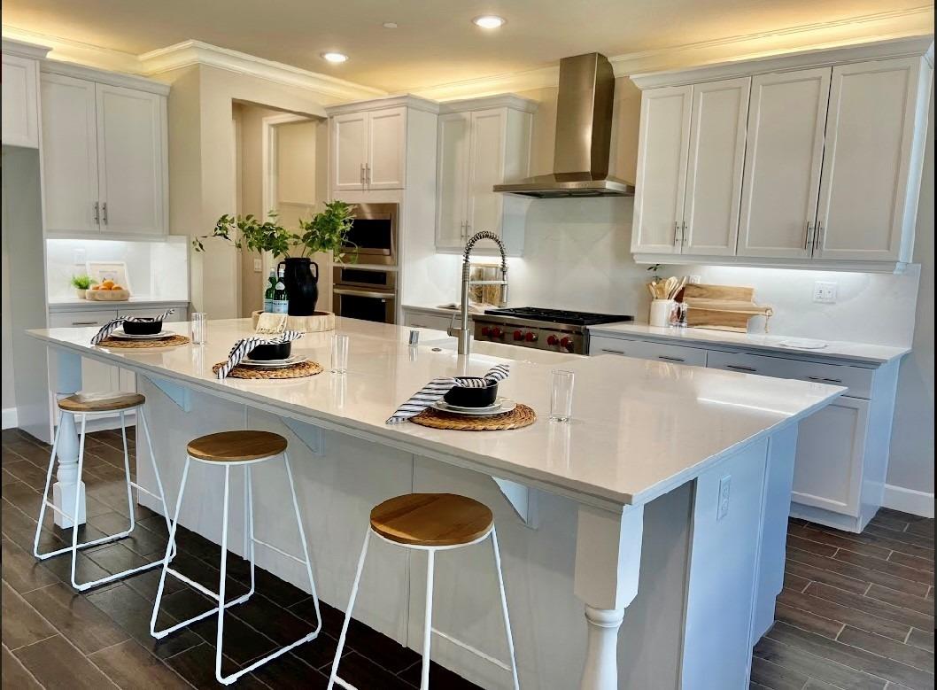 465 Bloom Lane Clovis, CA 93619 - Photo 3 of 16 a kitchen with a stove a sink and a refrigerator