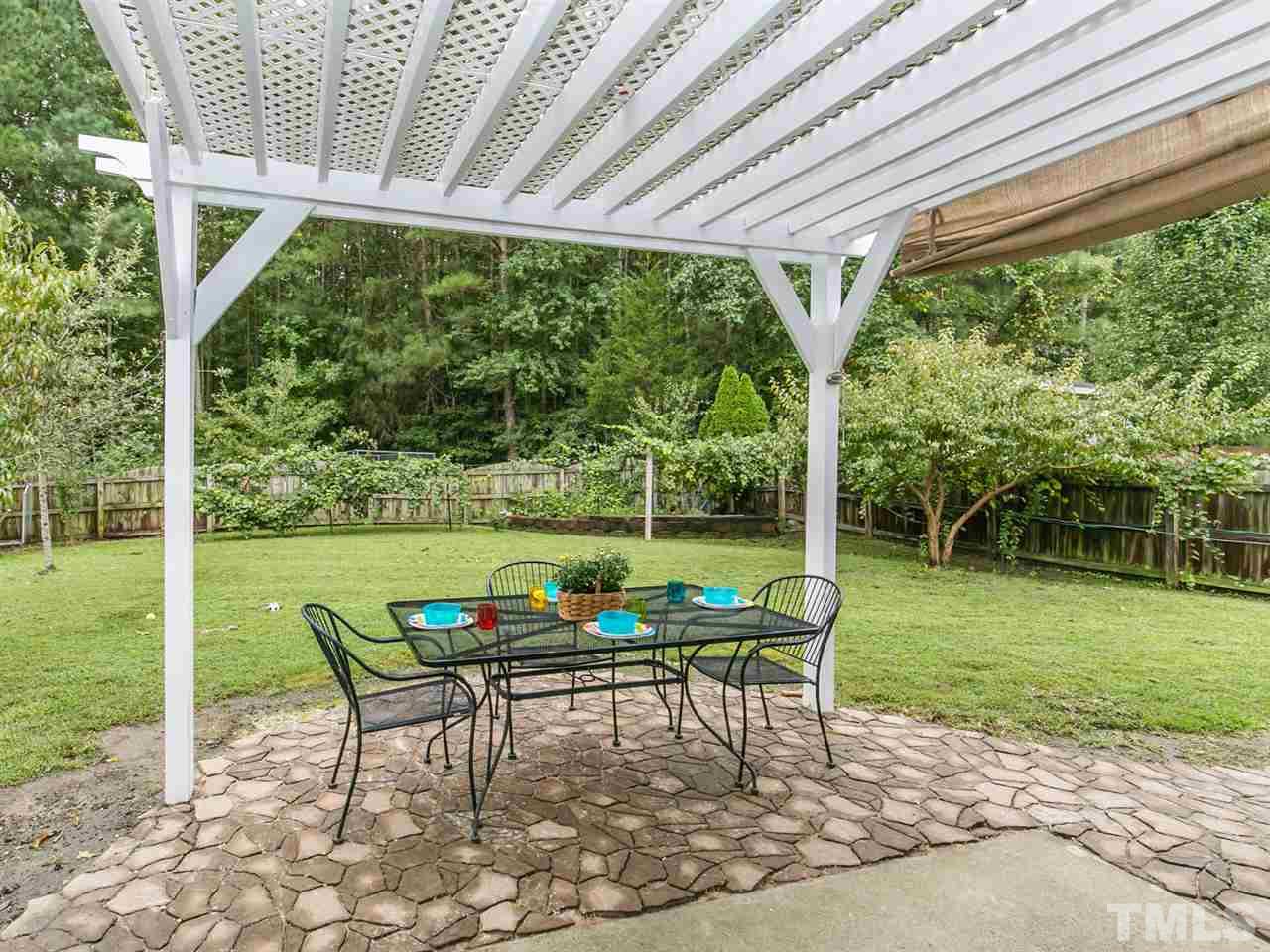 2880 Orchard Trace Way Raleigh, NC 27610 - Photo 20 of 22 Beautiful pergola and patio over-looking a park-like backyard.