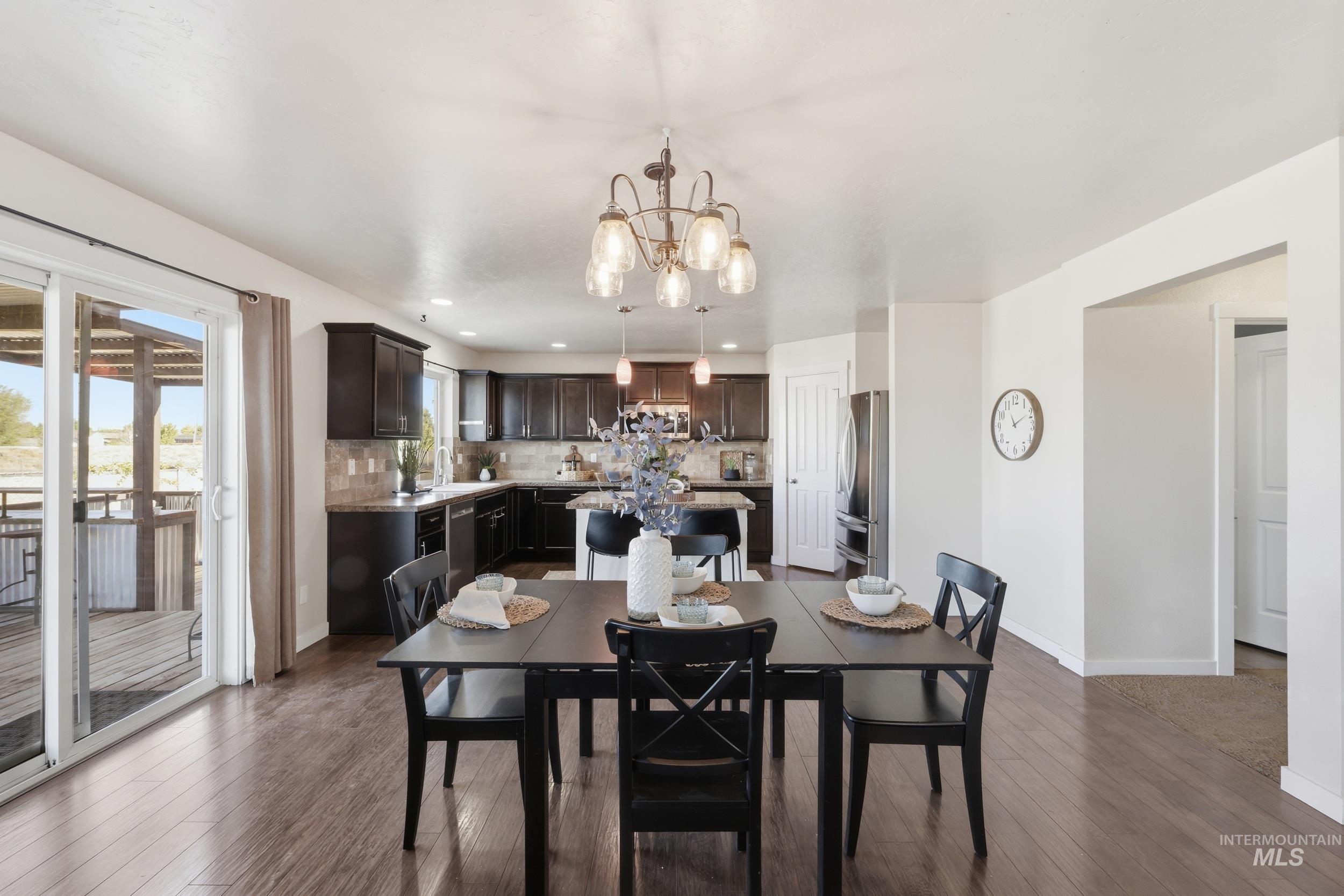 4855 South Chex Way Boise, ID 83709 - Photo 17 of 47 Open-concept kitchen and dining area featuring dark wood-finish flooring
