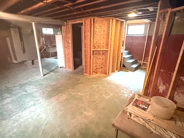 a view of a room with wooden floor and furniture