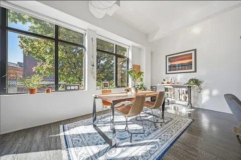 a dining room with furniture wooden floor and a rug