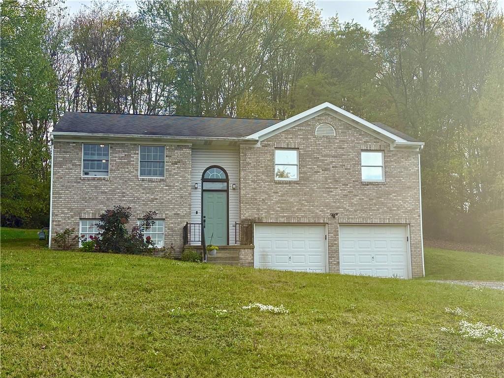 2917 Darlington Road Beaver Falls, PA 15010 - Photo 1 of 4 a front view of a house with garden