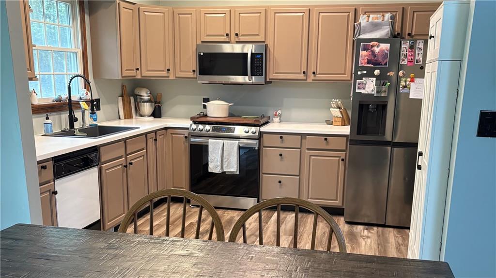 2917 Darlington Road Beaver Falls, PA 15010 - Photo 2 of 4 a kitchen with stainless steel appliances granite countertop a refrigerator sink and stove