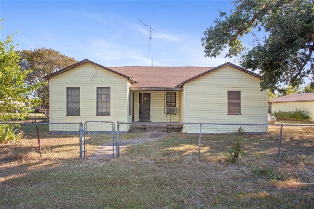 100 County Road 120 C Riesel, TX 76682 - Photo 1 of 25 View of front of home with a porch, a gate, a fenced front yard, and a shingled roof