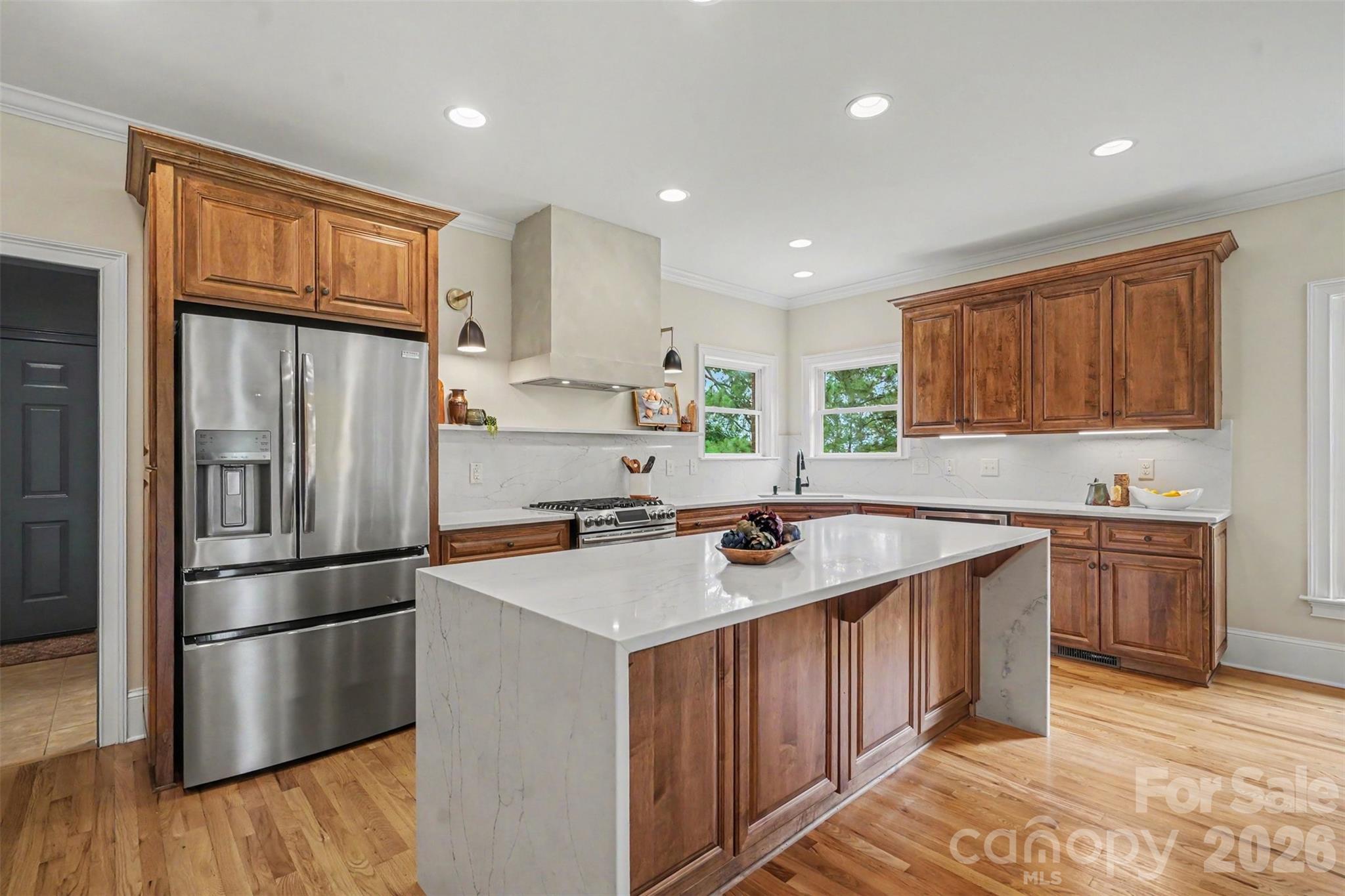 4445 Rowell Road Lancaster, SC 29720 - Photo 7 of 37 a kitchen with a refrigerator a sink and wooden cabinets