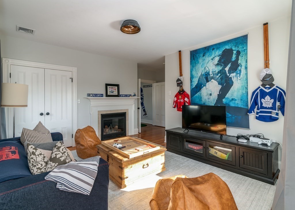 4 Mann Street Hingham, MA 02043 - Photo 16 of 22 a living room with furniture and a flat screen tv