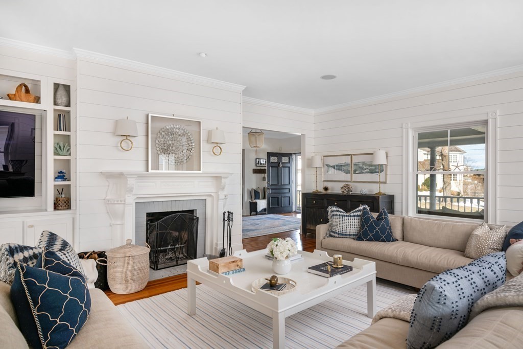 4 Mann Street Hingham, MA 02043 - Photo 3 of 22 a living room with furniture a flat screen tv and a fireplace