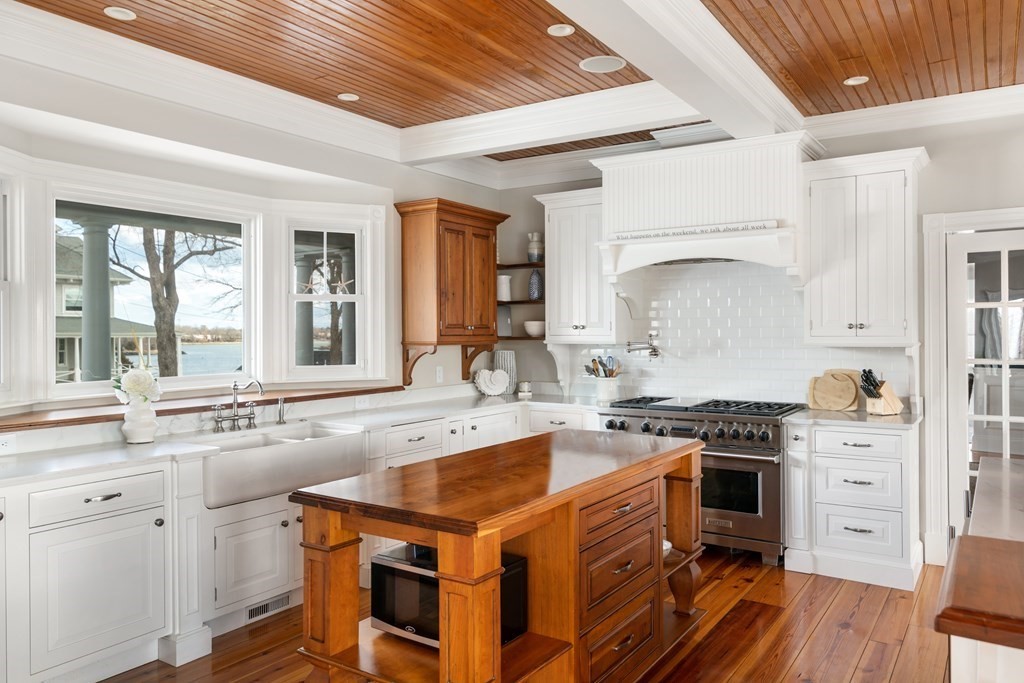 4 Mann Street Hingham, MA 02043 - Photo 7 of 22 a kitchen that has a sink a stove and cabinets