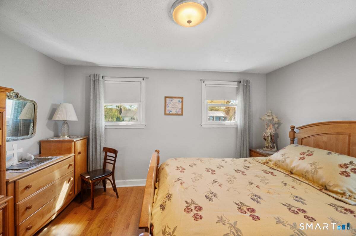 21 Brookside Circle Wethersfield, CT 06109 - Photo 15 of 39 a bedroom with a bed and wooden floor