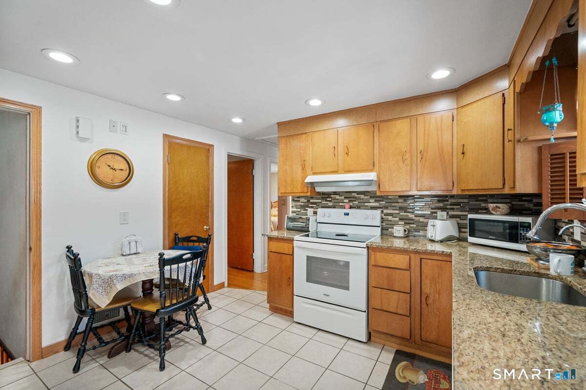 21 Brookside Circle Wethersfield, CT 06109 - Photo 17 of 39 a kitchen with a stove a sink cabinets and appliances