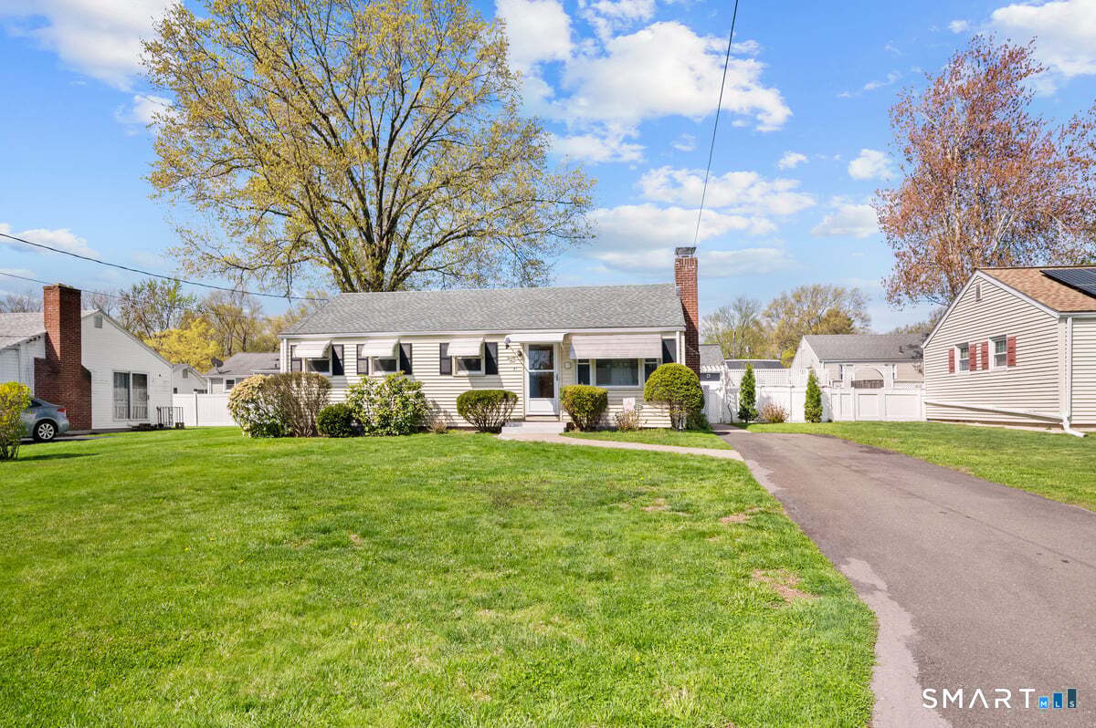 21 Brookside Circle Wethersfield, CT 06109 - Photo 2 of 39 a front view of a house with garden