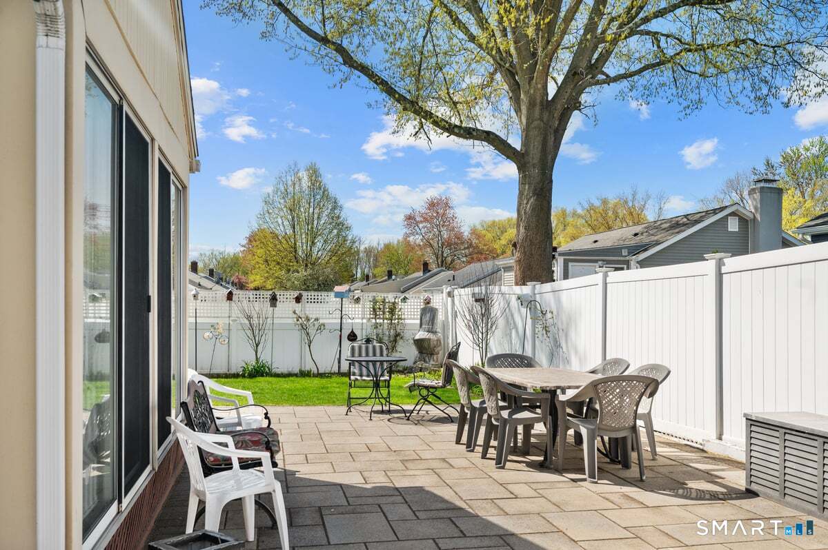 21 Brookside Circle Wethersfield, CT 06109 - Photo 27 of 39 a view of a chairs and table in patio with a backyard