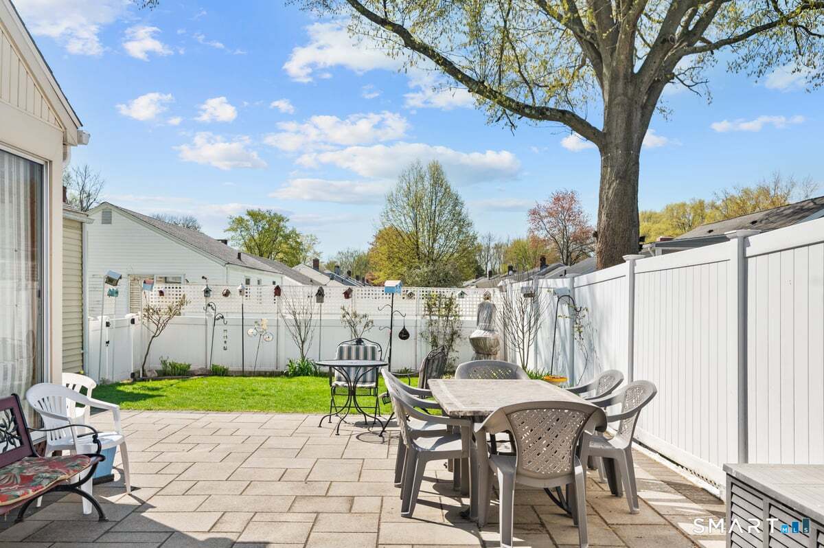 21 Brookside Circle Wethersfield, CT 06109 - Photo 28 of 39 a view of a patio with a table and chairs