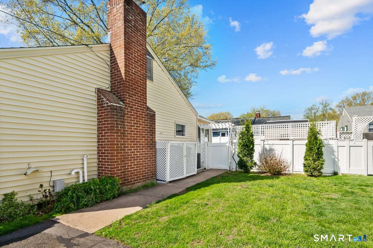 21 Brookside Circle Wethersfield, CT 06109 - Photo 29 of 39 a view of a white house with a yard