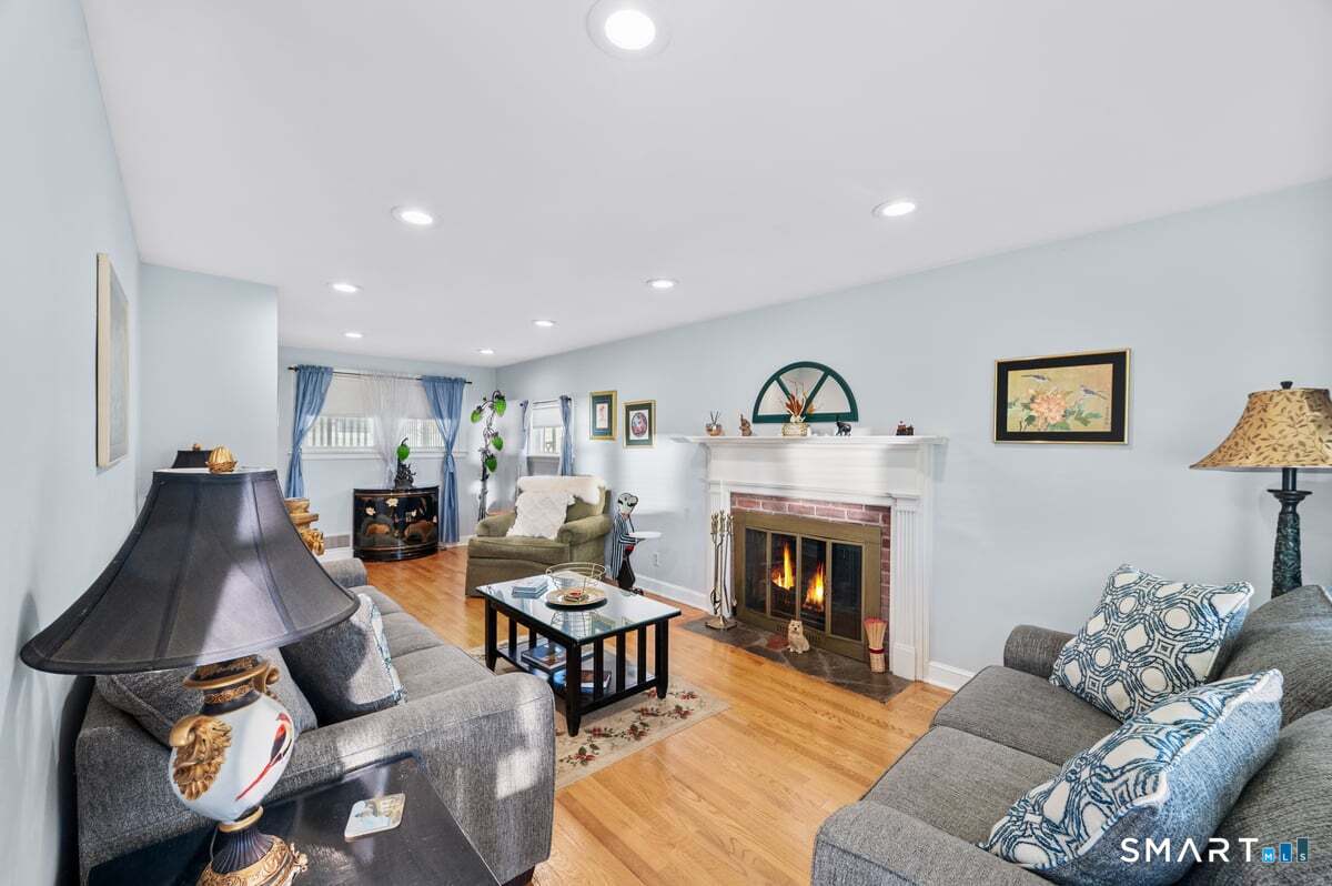 21 Brookside Circle Wethersfield, CT 06109 - Photo 6 of 39 a living room with furniture and a fireplace
