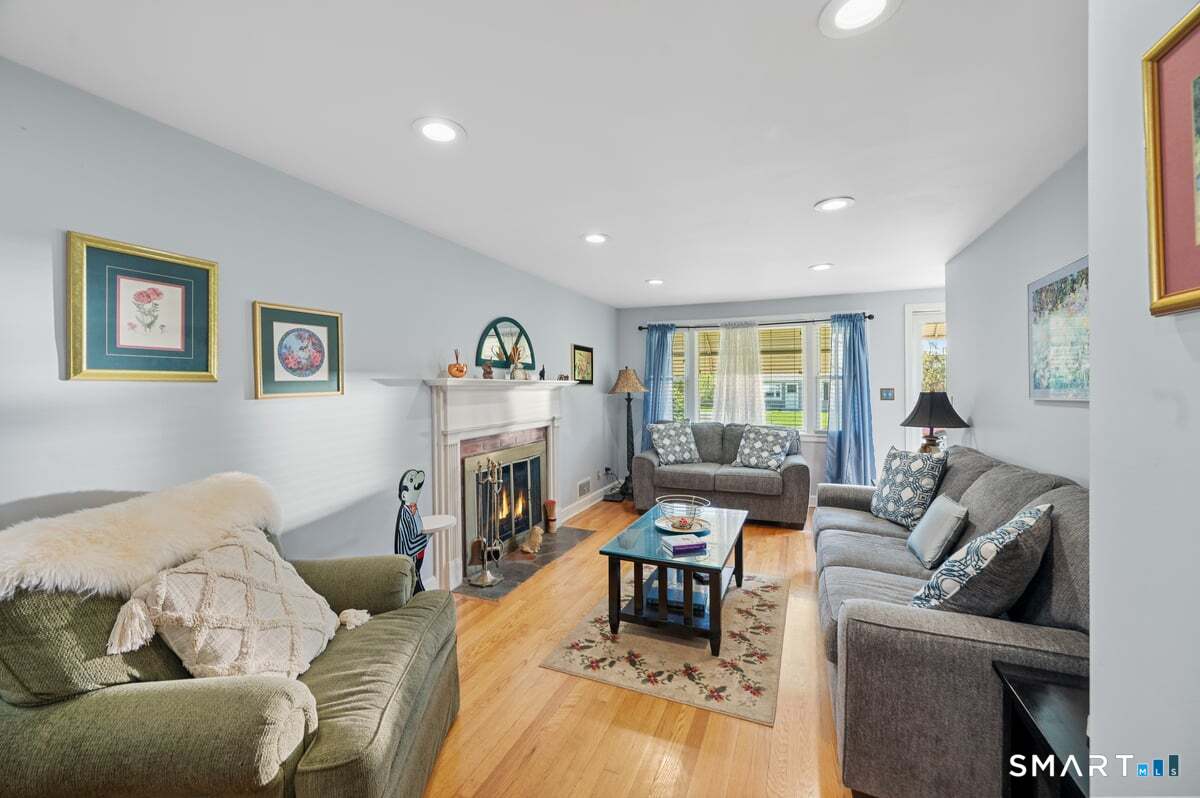 21 Brookside Circle Wethersfield, CT 06109 - Photo 7 of 39 a living room with furniture and a wooden floor