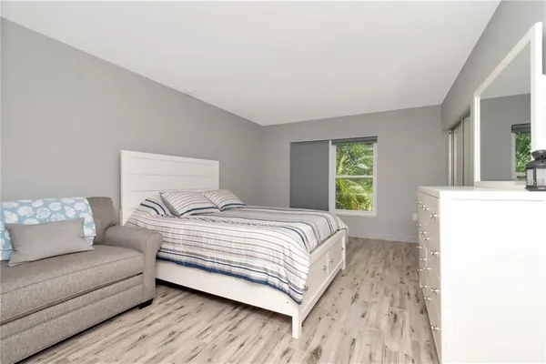a bedroom with a bed and a couch