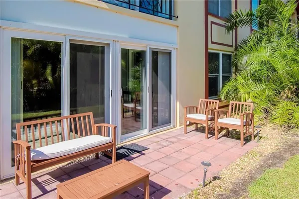 a swimming pool with outdoor seating and a couch