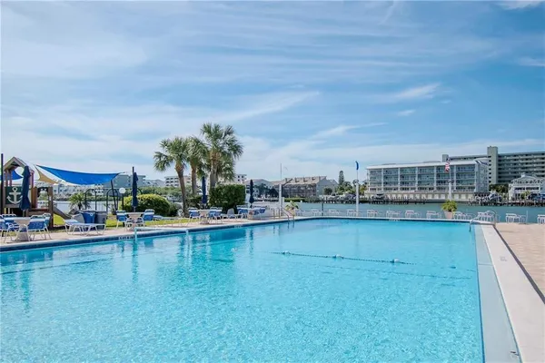 a view of a swimming pool with outdoor seating