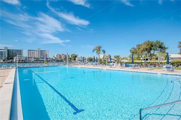 a view of a swimming pool with an outdoor seating