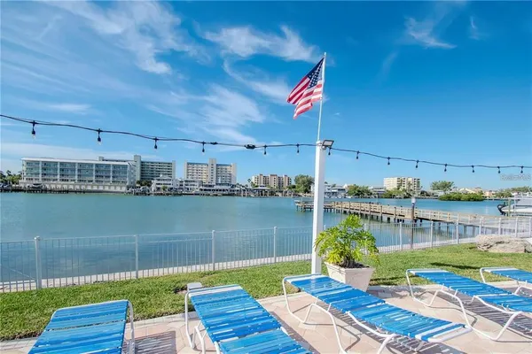 a view of a lake with couches chairs