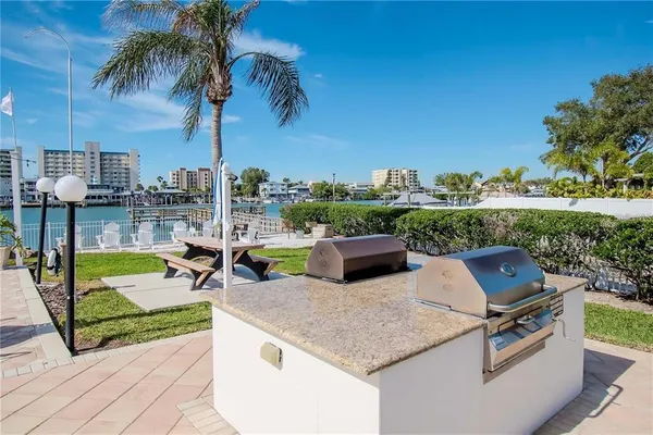 a view of a swimming pool with a patio and a yard