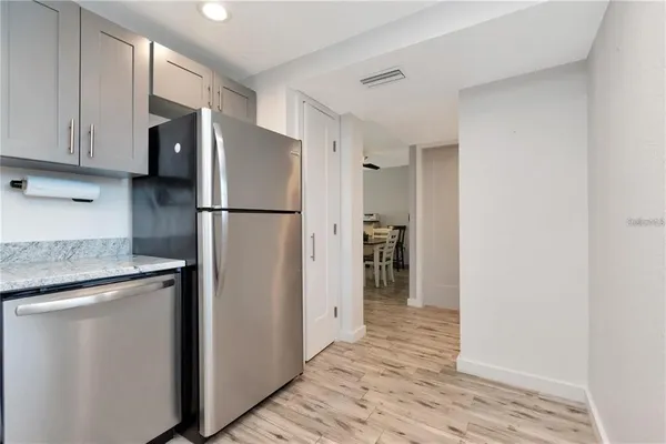 a white refrigerator freezer and a stove sitting inside of a kitchen
