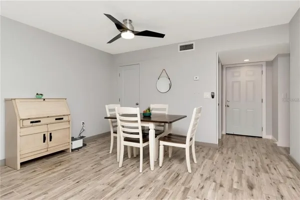 a dining room with furniture and wooden floor