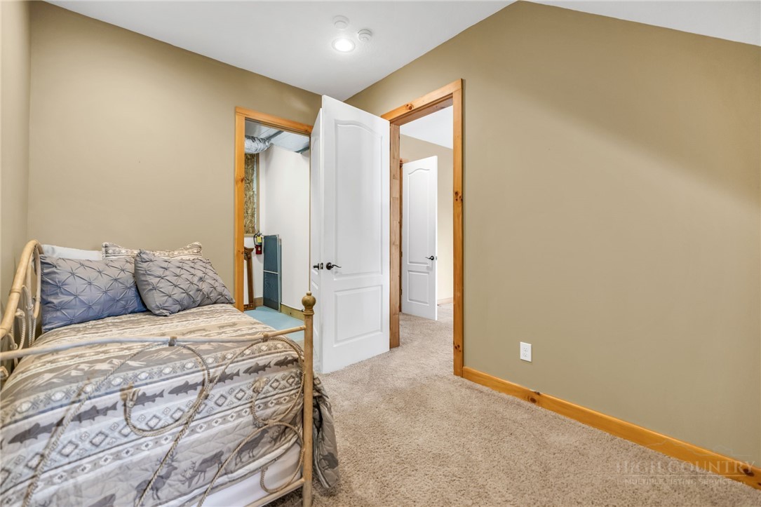 7994 3 Top Road Todd, NC 28684 - Photo 29 of 50 a room with a bed and a painting on the wall