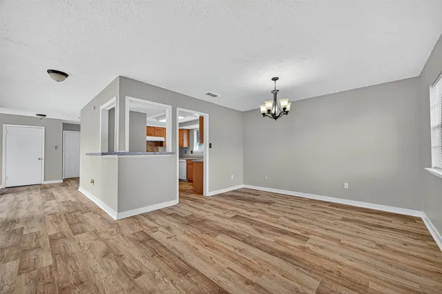 a view of a livingroom with wooden floor and a ceiling fan