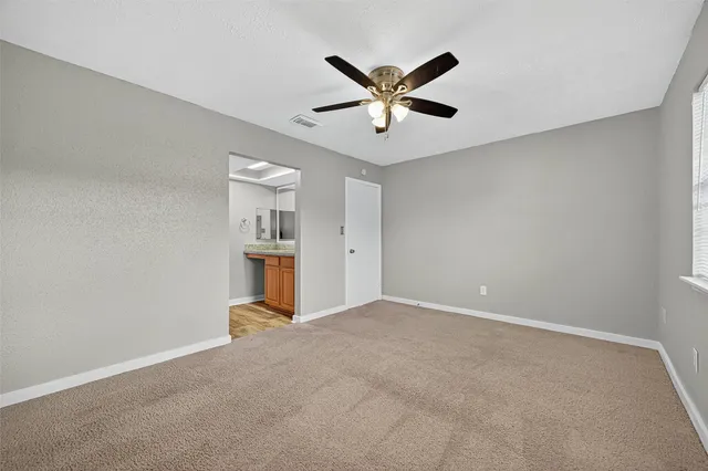 a view of a livingroom with a ceiling fan and window