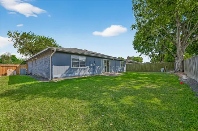 a view of a house with a backyard