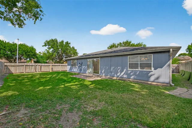 a view of a house with a backyard