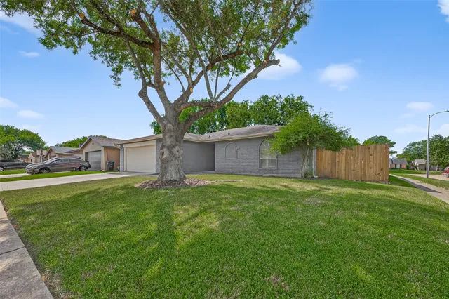 a tree in front of a white house